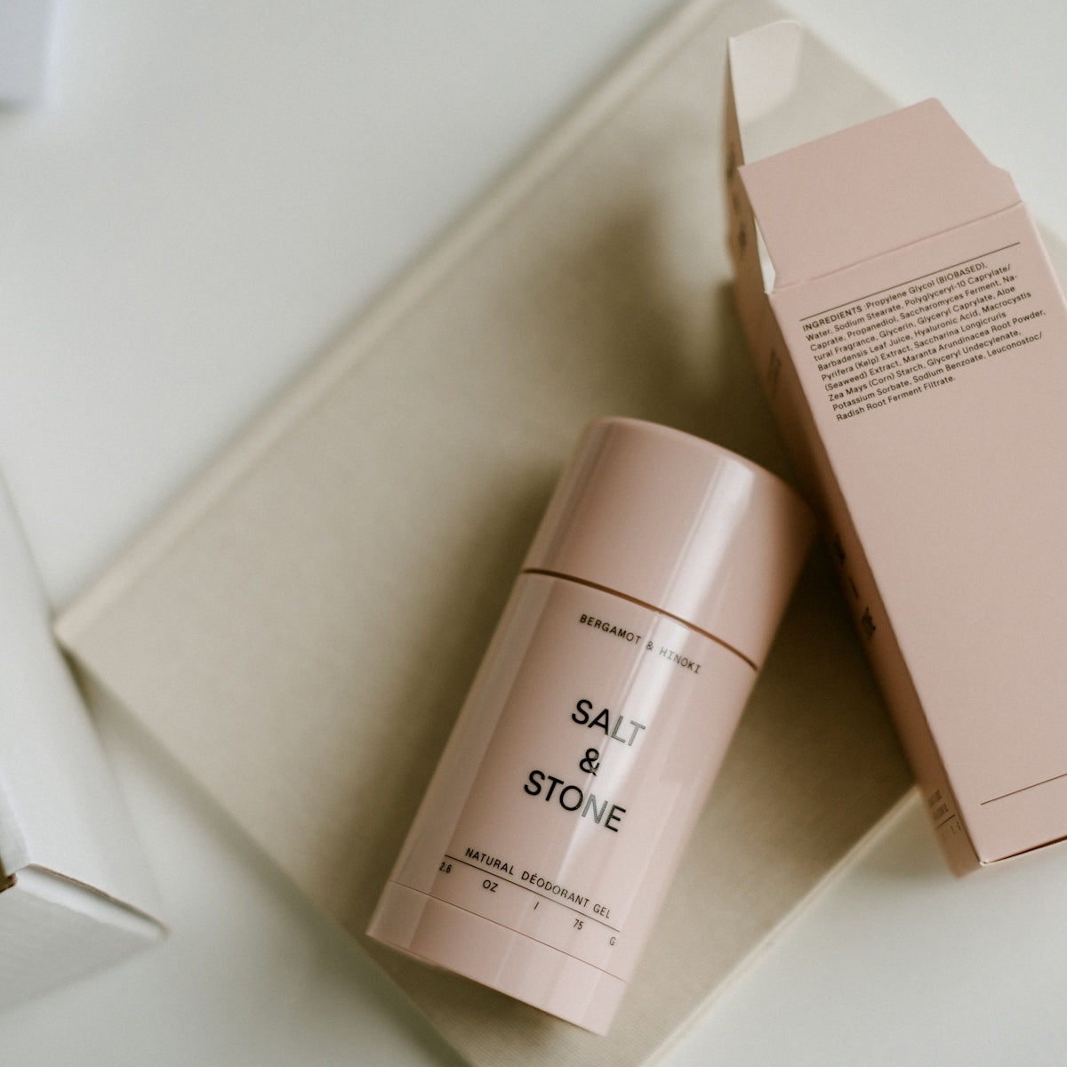a pink container sitting on top of a table next to a box