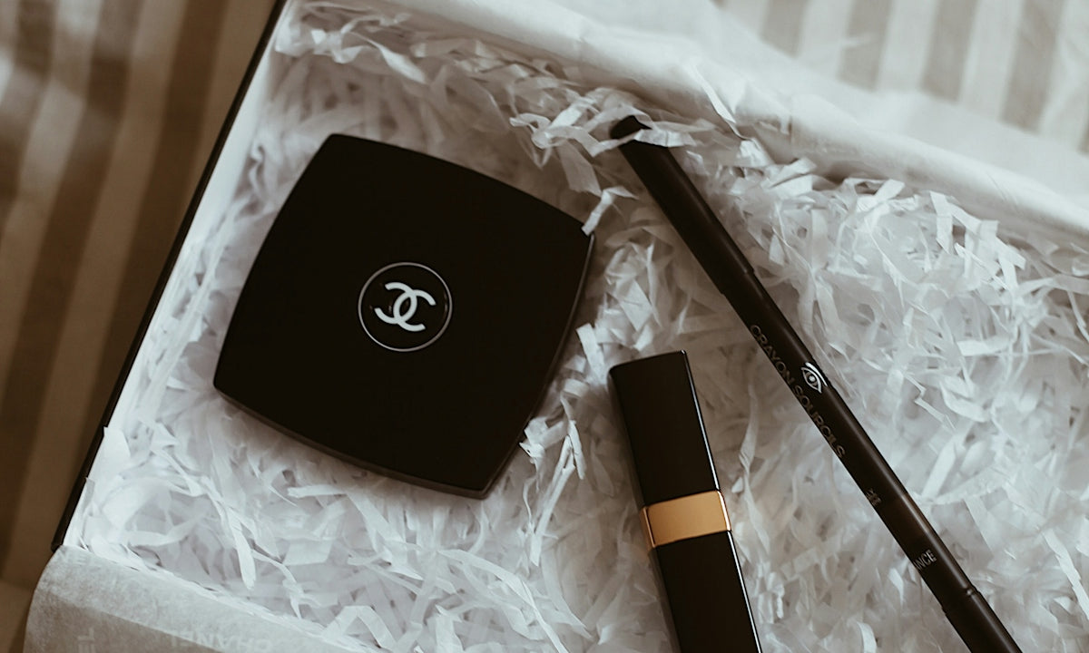 A chanel box with a pen and a watch