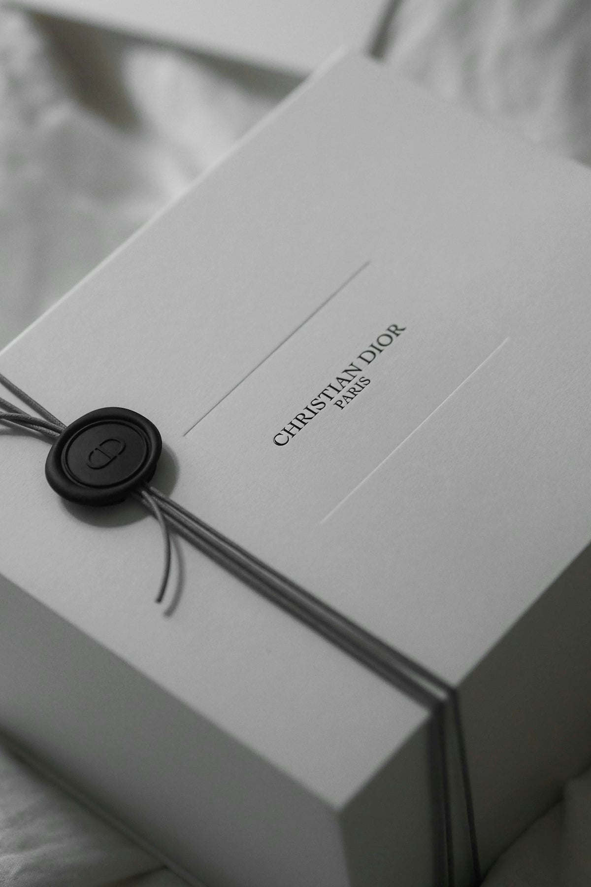 White christian dior gift box with ribbon and wax seal