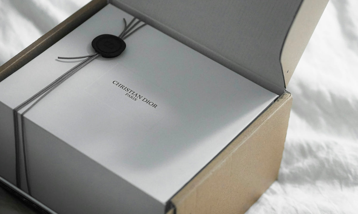 Dior gift box with ribbon and ribbon on white surface