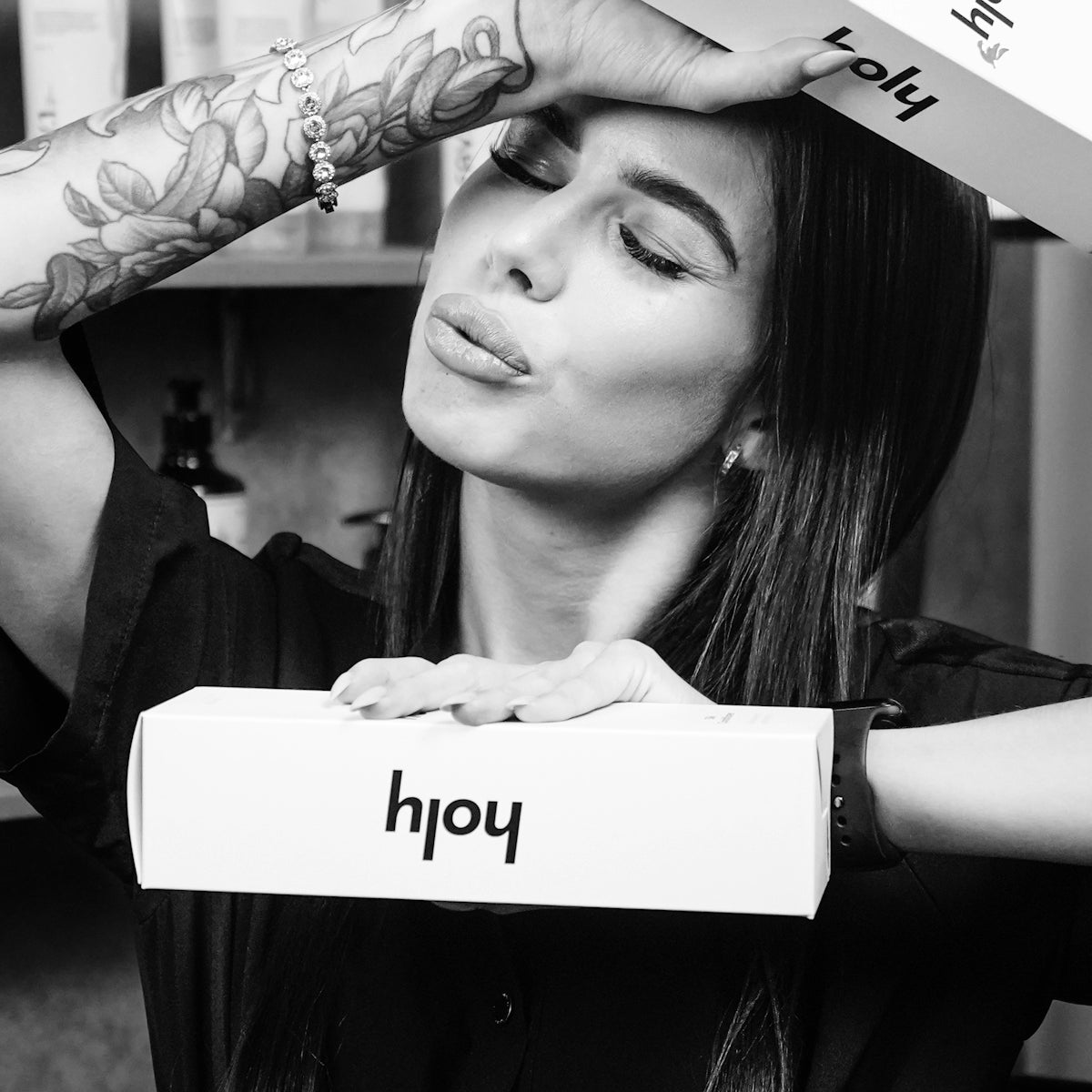 Woman holding boxes with her head and hands