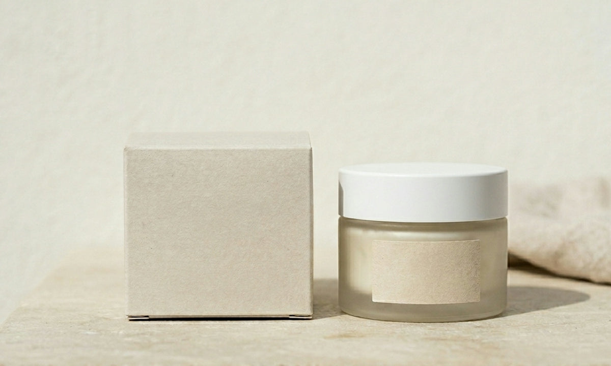 Frosted glass jar and box on a light surface.
