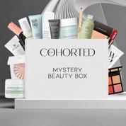 Cohorted Mystery Beauty Box gift set with assorted skincare and makeup products inside a branded box.