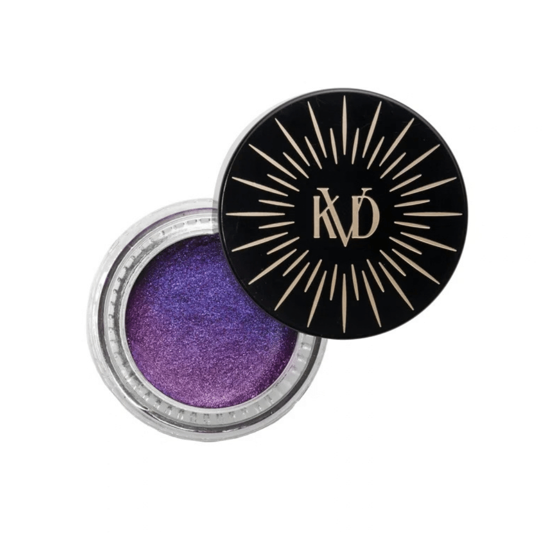 Cohorted The Electric Bloom Edit beauty box displayed on a cream pedestal, surrounded by purple and pink flowers in a botanical setting, beauty boxes, UK, Gift,  KVD Beauty, Dazzle Gel Hyper-Metallic Eyeshadow,VIOLET AURORA 20