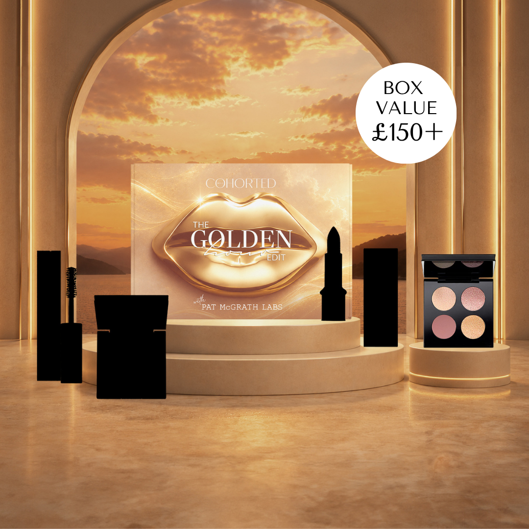 Makeup display with 'The Golden Lip' collection by Pat McGrath Labs against a sunset backdrop. Cohorted subscription beauty box featuring skincare and makeup products in a sleek, branded box for curated beauty surprises. Pat McGrath Labs. Celestial Odyssey Luxe Quad New York Edition - Bronze Borealis