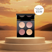 Makeup palette with sunset and lake background. Makeup display with 'The Golden Lip' collection by Pat McGrath Labs against a sunset backdrop. Cohorted subscription beauty box featuring skincare and makeup products in a sleek, branded box for curated beauty surprises. Pat McGrath Labs. Celestial Odyssey Luxe Quad New York Edition - Bronze Borealis